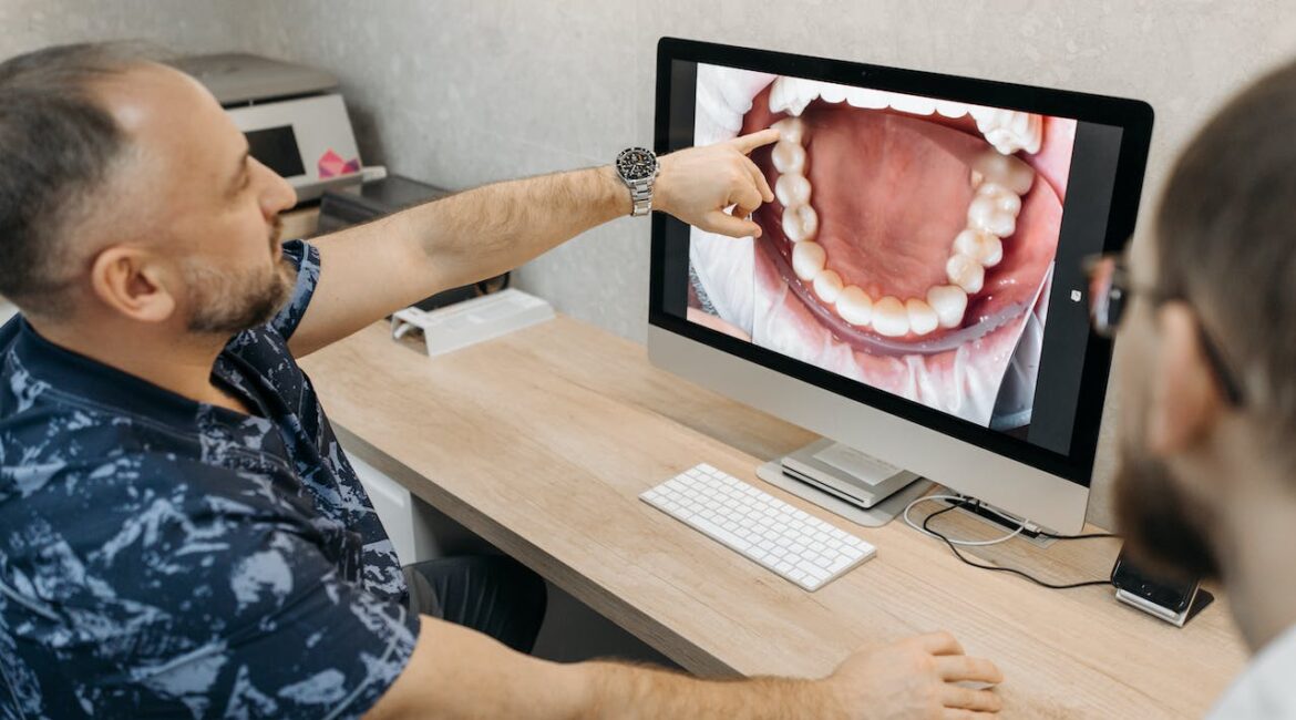 dentist showing patient picture of teeth