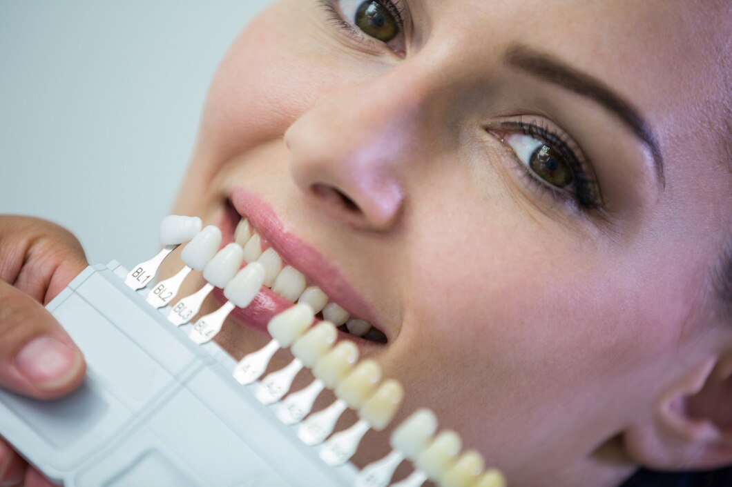 Dentist examining patient teeth shades for bonding treatment in Pickering Ontario